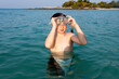 © travelview - young boy  enjoying the sea and starts snorkeling