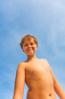 © travelview - happy smiling young boy with background blue sky