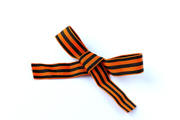 black orange strip ribbon bow surface close up isolated on white background.