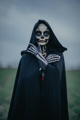 Wall Mural - Portrait of woman in Halloween costume of death with painted skeleton on her body and sugar skull makeup.