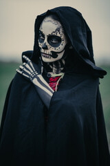 Wall Mural - Portrait of woman in Halloween costume of death with painted skeleton on her body and sugar skull makeup.