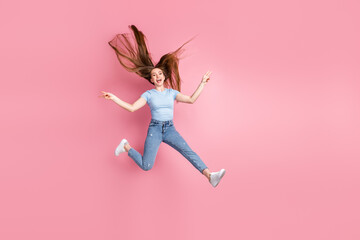 Canvas Print - Photo portrait of screaming woman showing two v-signs with fingers jumping up isolated on pastel pink colored background