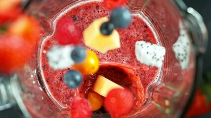 Wall Mural - Fresh berries smoothie blended in blender, top view. Healthy eating concept. Super slow motion filmed on high speed cinematic camera.