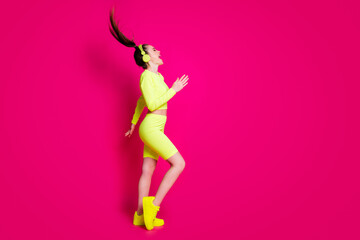 Poster - Full length body size profile side view of her she attractive slim cheerful girl listening pop rock music having fun enjoying dancing isolated bright vivid shine vibrant pink fuchsia color background