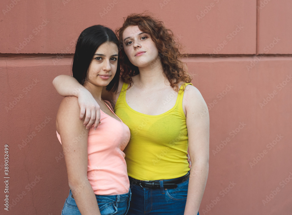 two girls of generation z hug each other while posing for a photo, two ...
