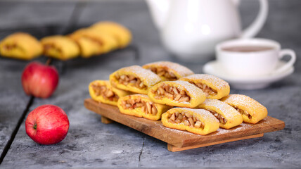 Wall Mural - Delicious homemade apple cookies on wood board with a cup of tea.