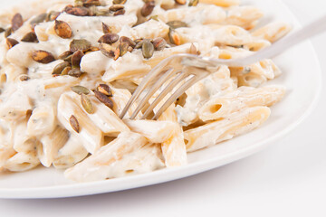 Sticker - Pasta with blue cheese and cream sauce, sprinkled with roasted pumpkin seeds eaten with a fork