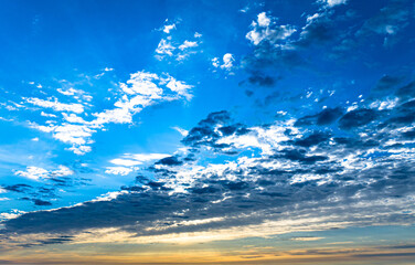 Wall Mural - Dramatic blue sky with multicolor clouds at sunset or sunrise