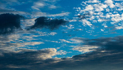 Wall Mural - Dramatic blue sky and multicolor clouds at sunset or sunrise
