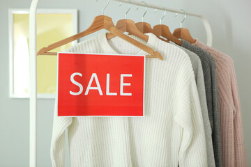 Wall Mural - Clothes on the rail and a sale sign. Final sale, discounts