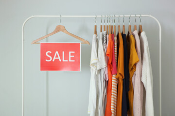 Wall Mural - Clothes on the rail and a sale sign. Final sale, discounts