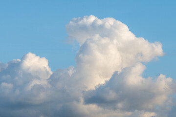 Cloudscape of fluffy clouds against a blue sky, as a nature background
