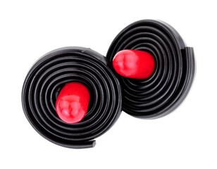 Liquorice spinning tops, soft liquorice strips wrapped around a red liquorice torpedo isolated on a white background