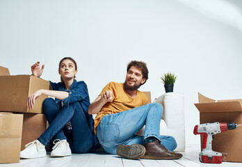 Men and women in a new apartment moving repair work boxes stuff