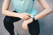 © boyloso - Cropped shot of runner woman checking health status and fitness progress on her smart watch.