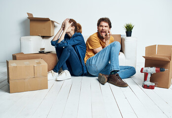 Man and woman with empty boxes Moving to an apartment indoor interior