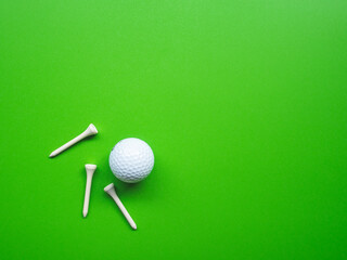 Golf equipment flat lay on green background. Top view