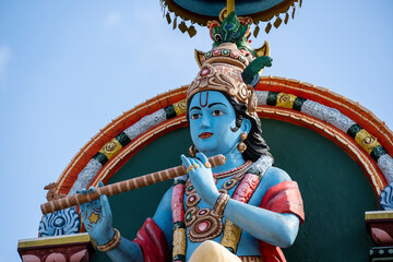 Wall Mural - Detail stone statue in Sri Krishnan temple on south indian hindu temple in Singapore on blue sky background