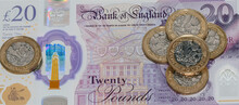 British Curreny. Twenty Pound Note With Pound Coins Scattered On It - In A Web Banner Format.