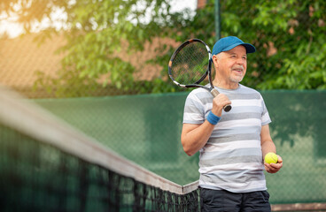 smiling, sporting, active senior man playing tennis in the outdoor, sports pensioner, sport concept