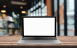 © DEEP PIXEL - Laptop blank screen on table with blur coffee shop background.