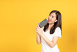 © Kiattisak - Happy smiling asian young girl with earphones listening music