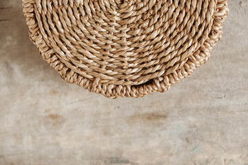 Details of a round wicker basket on an old wooden background. Top view. Copy, empty space for text