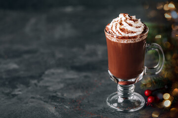 Wall Mural - Hot chocolate cocoa with whipped cream in glass on dark background, copy space.