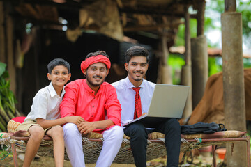 Wall Mural - Young indian farmer and agronomist or banker discuss at home