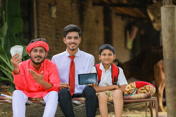 Wall Mural - indian farmer and agronomist or banker showing smartphone at home