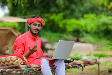 Sticker - technology concept : Young indian farmer using laptop at home