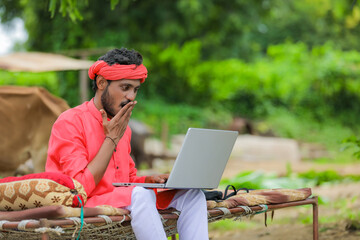 Sticker - technology concept : Young indian farmer using laptop at home