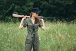 © SHOTPRIME STUDIO - Woman on outdoor arms behind head green jumpsuit black cap lifestyle fresh air