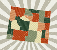 Wyoming Vintage Map. Grunge Poster With Map Of The Us State In Retro Color Palette. Shape Of Wyoming With Sunburst Rays Background. Vector Illustration.