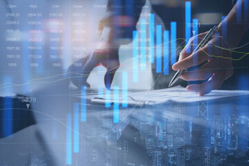 Businessman analyzing stock market report with financial graph on virtual screen for business finance and investment concept