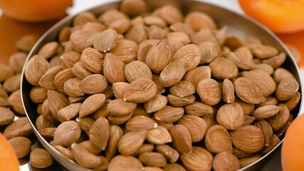 Sticker - Some shelled Apricot Kernels on a rotating plate (seamless loopable)