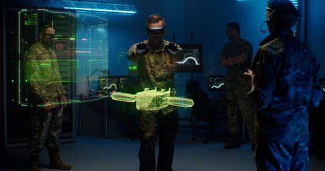 Military men controlling holographic model of drone