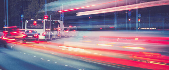 Cars moving on the road in city in late evening