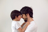 Fototapeta  - father and son on a white background at home