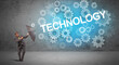 © ra2 studio - Businessman defending with umbrella from TECHNOLOGY inscription, technology concept