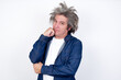 © Jihan - Face expressions and emotions. Thoughtful Handsome mature caucasian man with afro gray hair standing over white background holding hand under his head, having doubtful look.