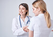 © SHOTPRIME STUDIO - Happy woman doctor in medical gown with stethoscope and patient back view