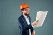 © SHOTPRIME STUDIO - A man in orange paint blueprints in the hands of a construction industry official