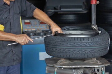 technician,Mechanic is retreating, replacing the tires and mag wheels in the service center.