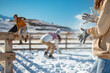 © cppzone - Girl shakes off snow from hands during playing snowballs in mountains