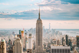 Fototapeta  - Close up view of the Empire State Building and the New York city skyline on a beautiful blue sky day
