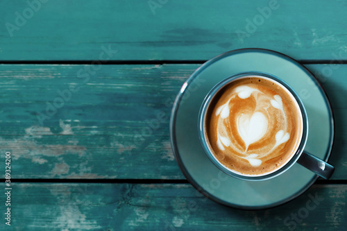 Fotografía Hot Coffee Latte Cup on Blue Wooden Table
