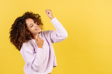 Wall Mural - Young african american woman on yellow copy space background