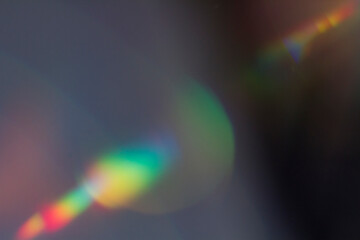 Wall Mural - colourful lens flare and haze on black background.