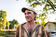 © Nexa - Portrait of smiling beautiful male farmer. Man at farm in summer day. Gardening activity. Brazilian elderly man. Latino people.